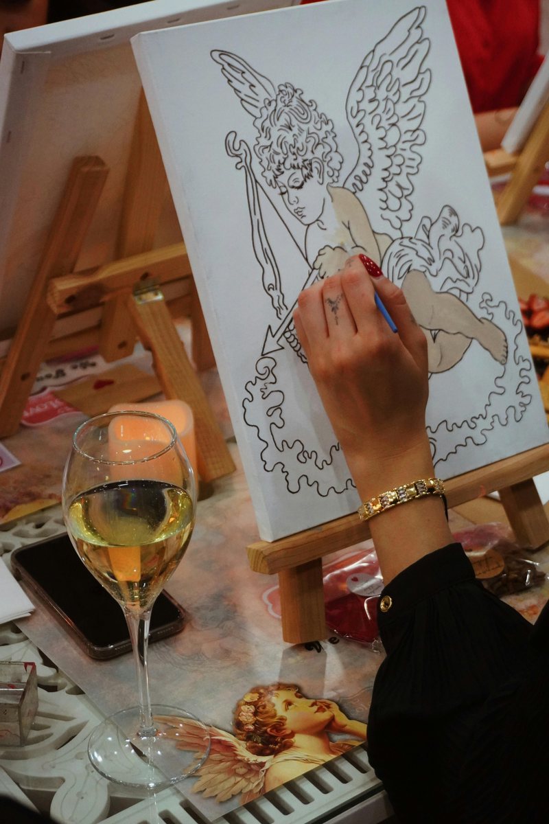 Sip and paint event setup with painting and wine